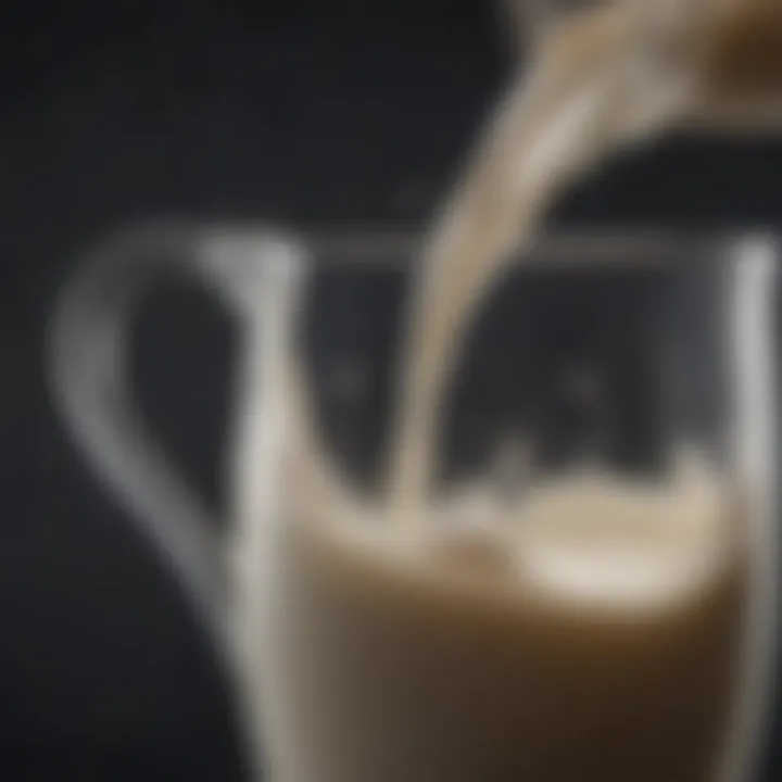 A close-up of whole milk flowing from a jug into a glass