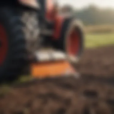 Close-up of a compact tractor blade in action on a field